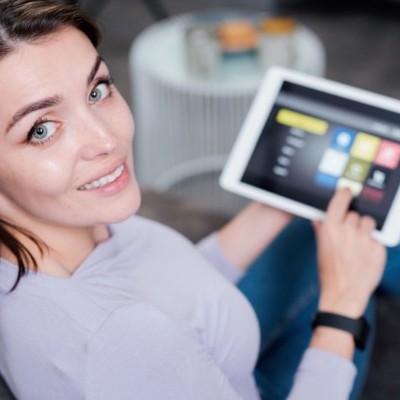 5e72146108c35_happy-young-woman-with-digital-tablet-choosing-ldbsq48