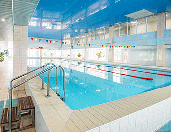 view-of-indoors-swimming-pool-with-metal-ladder-XSB5CJD